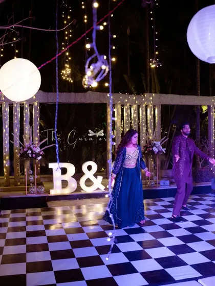 The groom and his sister share a dance, a heartwarming moment of family love. The marquee letters in the background add a personal touch.