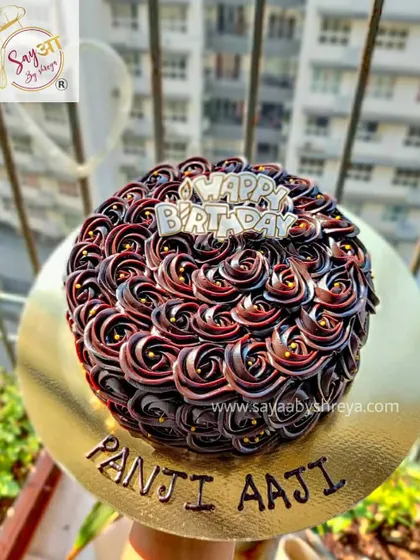 That rich double chocolate shine is something I'm very proud of. This cake, made for a 'Panji Aaji' (great-grandmother), features beautiful rosettes of dark chocolate ganache.