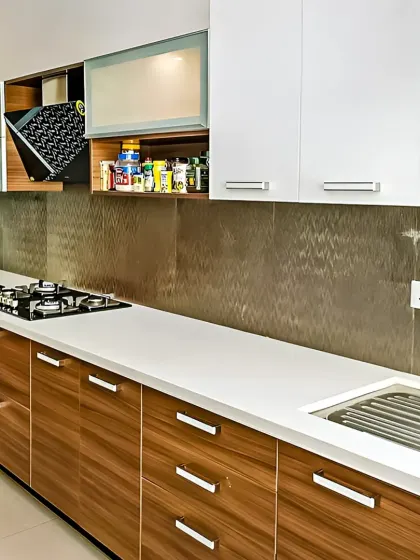 This kitchen showcases a mix of wood-grain and solid white cabinets with sleek metal handles. I included specialized storage like a pull-down dish rack to make daily tasks easier.