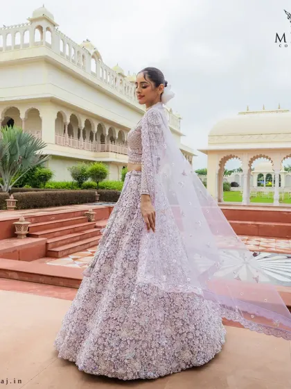 This pastel lilac lehenga with its flowing silhouette and exquisite 3D floral embroidery is a perfect blend of romantic charm and modern design.