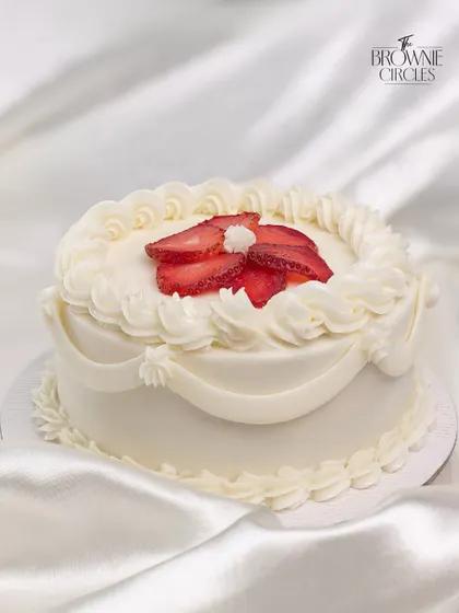 A special Valentine's bento cake with delicate piping and fresh strawberries. These custom designs are perfect for making someone feel loved.