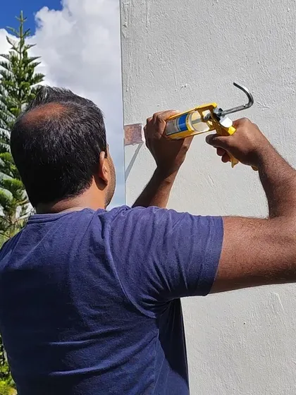 A team member assists in securing a Yantra. The process is clean, quick, and non-invasive, ensuring the home's aesthetic is preserved while its energetic quality is significantly improved.