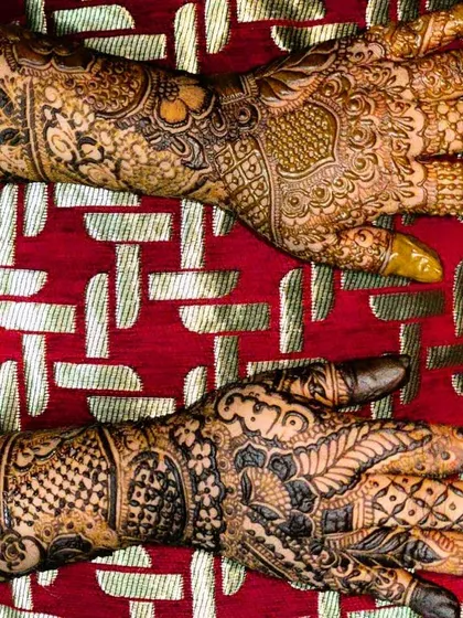 A view of the back of the hands, showcasing a different set of intricate patterns.