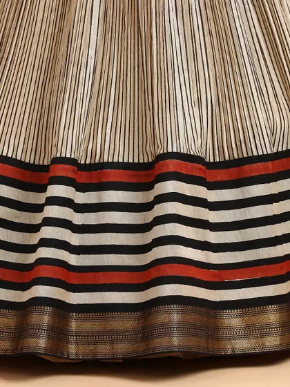 A detailed shot of the striped silk skirt, highlighting the texture of the fabric and the bold border design.