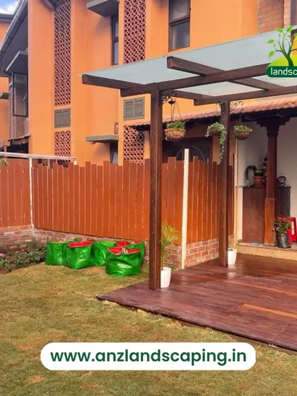 This image shows the side of the villa with a new wooden fence for privacy, a freshly laid lawn, and grow bags ready for a vegetable garden.
