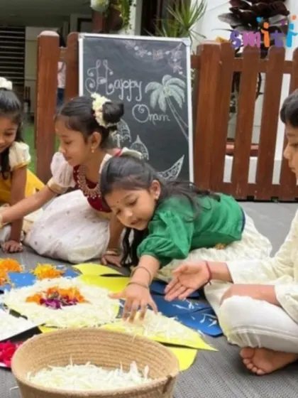Four children carefully place flower petals onto their Pookalam design. This activity enhances their fine motor skills and gives them a sense of ownership over the celebration.