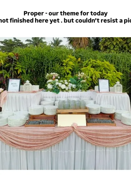 We never repeat a setup. This elegant outdoor buffet station, with its soft pink and white draping, was custom-designed to match the wedding's theme, ensuring a unique look.