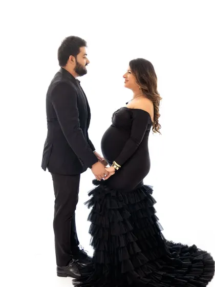 A classic, formal pose for a couple in elegant attire. This shows how we can create more traditional and stately portraits in the studio as well.