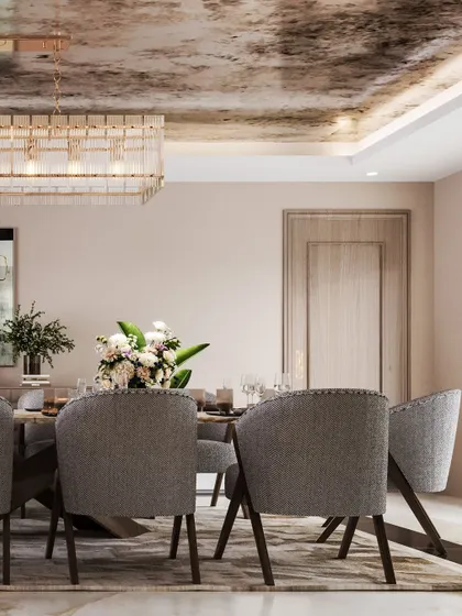 This angle provides a clearer view of the dining set, with its plush grey chairs and simple, elegant table setting.