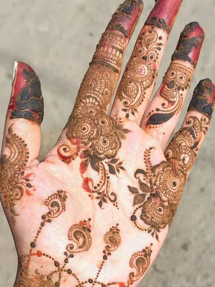 A minimalist design featuring delicate floral and paisley motifs scattered across the hand.