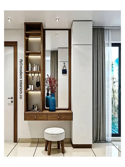 This floating dressing table is clean, modern, and space-efficient. The design includes two drawers and a tall side shelf unit with integrated lighting, all next to a full-height wardrobe for a seamless look.