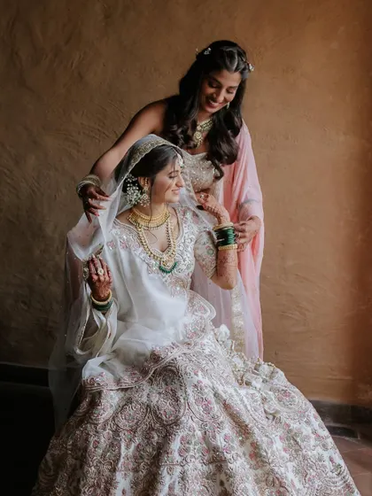 The sister helping the bride get ready. These are the moments that make a wedding so special.
