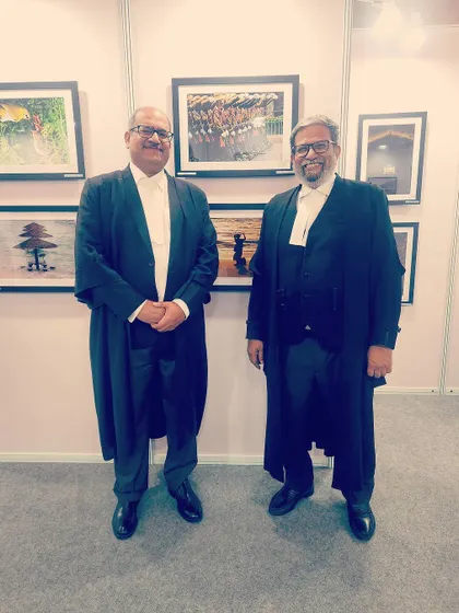 Posing with a colleague at a photo exhibition. It's always fun to appreciate the artistic talents within our community and share a moment of camaraderie outside the courtroom.