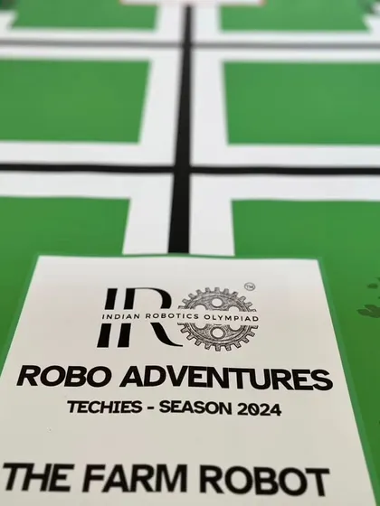 The official branding for the IRO Robo Adventures Techies Season 2024, "The Farm Robot," is displayed on the challenge mat, setting the theme for the competition.
