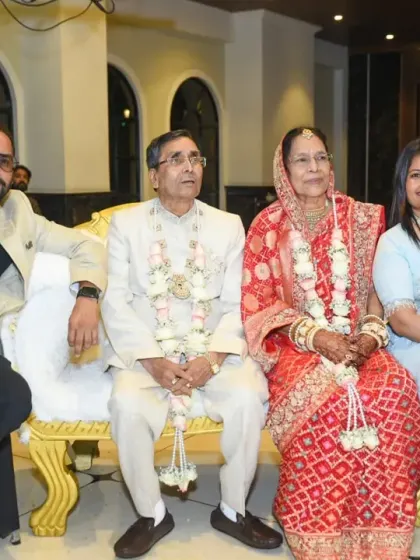 The couple seated with their children for a family portrait.