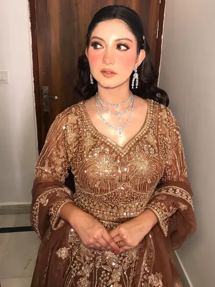 The full look, showing the beautiful brown and gold embroidered outfit.