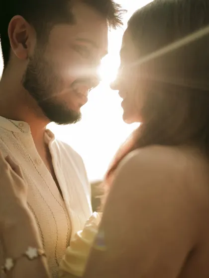 A beautiful silhouette created by the setting sun, highlighting the couple's connection in a warm, golden glow.