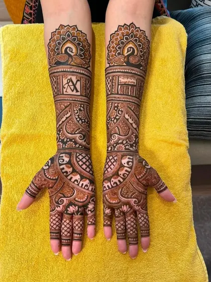 A full view of the personalized bridal design with 'A' and 'V' initials and peacock motifs.