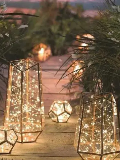 Geometric lanterns filled with twinkling lights create a modern and artistic lighting installation. I placed these along a garden path to guide guests and add a touch of contemporary elegance.