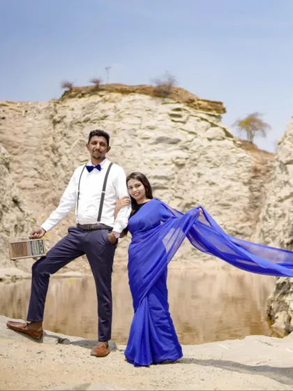 A stylish pre-wedding photo at a quarry location. The groom's suspenders and bow tie add a vintage touch to the modern, rugged backdrop.