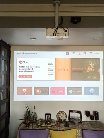 You don't always need a dedicated screen. For this installation in Thane, I mounted an Optoma projector and projected the image directly onto a plain wall, instantly creating a large screen for watching movies and shows.