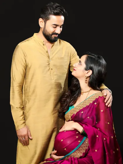 A loving couple portrait from a traditional themed maternity shoot. The way they look at each other shows their deep connection as they prepare to become parents.