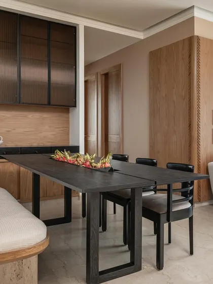 The dining area of Apartment 3201, designed for a cosmopolitan family. We blended natural oak tones with black-stained wood to create a palette that reflects the clients' Indian and Dutch heritage, resulting in a space that is both warm and modern.