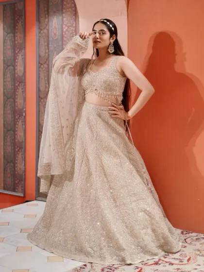 When your outfit shines brighter than the lights. This golden sequin lehenga is a dream for any wedding guest who loves to sparkle.