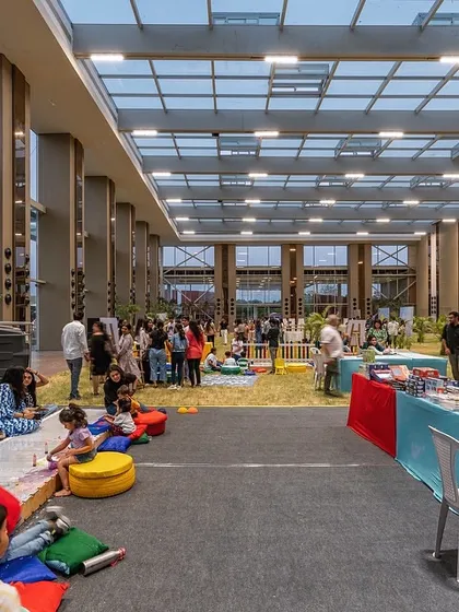 We designed this 40-foot-high glass pavilion to completely blur the line between indoors and outdoors. It allows for community events on a natural lawn while being protected from the elements, fostering a unique connection between people and nature.