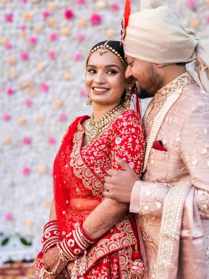 A sweet and candid moment. The groom whispering to his bride brings a genuine smile to her face.
