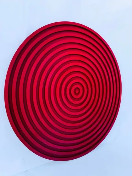 Our circular concentric circles sculpture in a brilliant red. The layered rings create a hypnotic, tunnel-like effect with depth and dimension.