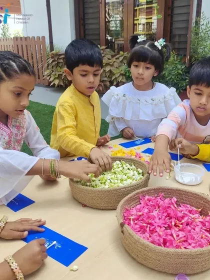 A group of children works on creating bookmarks decorated with fresh flower petals. This delicate craft develops their fine motor skills and appreciation for natural beauty.