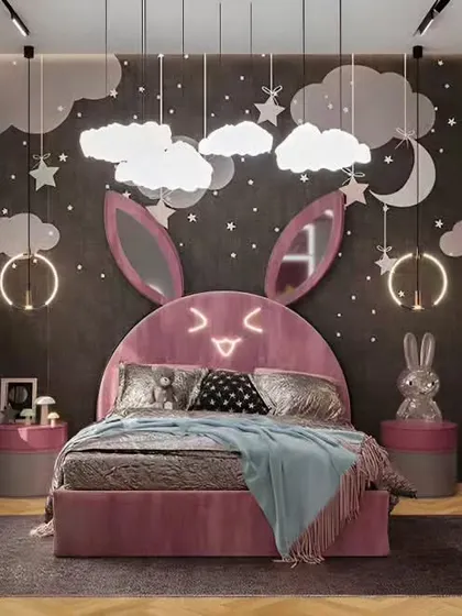 This adorable bunny-themed bedroom is perfect for a young child. We designed a custom pink bed with a light-up bunny-ear headboard, cloud-shaped pendant lights, and a cozy window seat for a playful and enchanting atmosphere.