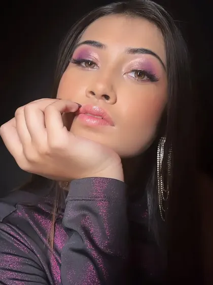 A glamorous shot featuring the purple eye makeup, paired with long, dangling earrings for a party-ready vibe.