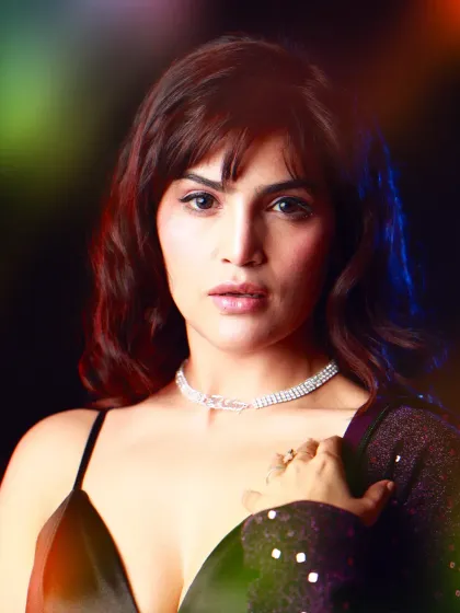 A close-up beauty shot with a colorful, bokeh-like lighting effect. This technique adds a touch of magic and glamour, focusing on the model's direct and engaging expression.