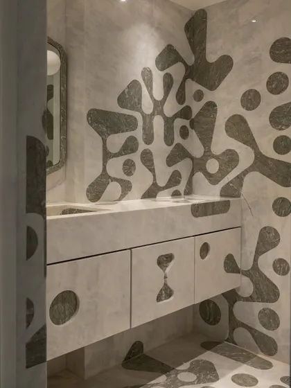 Another view of the powder room, showcasing the custom-shaped mirror that echoes the organic forms of the stone inlay.