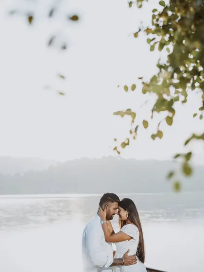 A minimalist and romantic shot of the couple against the bright, reflective water.