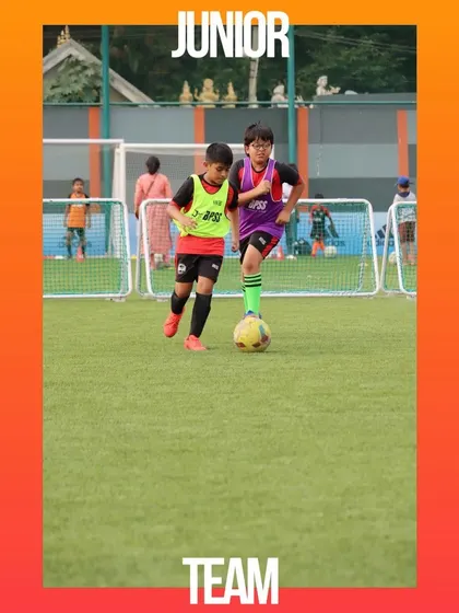 Two junior players focused on the ball during an internal match. I create opportunities for players to test their skills in a real-game environment.