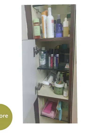 Another "before" shot of a messy cabinet next to the dressing table mirror.