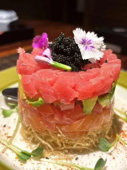 Our Salmon Tuna Tartare is a tower of flavor. Layers of finely diced fresh salmon and tuna are mixed with avocado and topped with caviar for a truly luxurious appetizer.