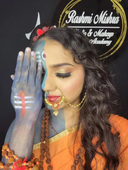 The hand covering half the face emphasizes the duality of the Ardhanarishvara concept, a technique in creative makeup storytelling.