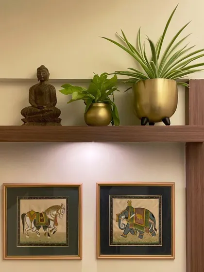 Creating a small green corner on a shelf can instantly warm up a space. Here, a set of my gold metal planters is styled with a Buddha statue, creating a peaceful and inviting vignette.