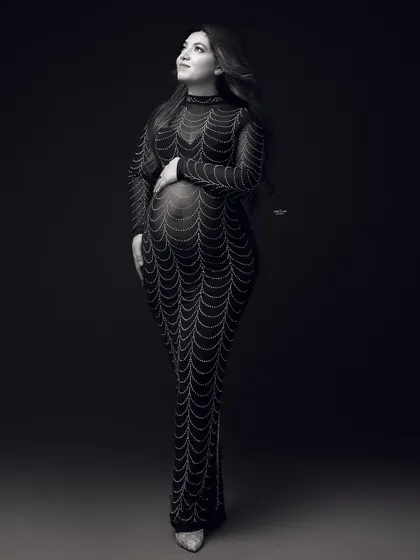A full-length black and white shot of the embellished gown, giving it a classic, old-Hollywood feel.