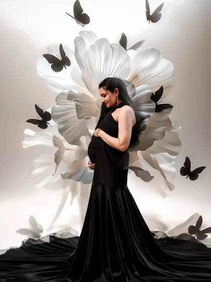 We believe every mother-to-be deserves a portrait that is as magical as the life she is creating. This shot combines an elegant black gown with artistic butterfly edits for a truly dreamy effect.