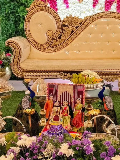 A close-up of the offerings and traditional dolls used in the baby shower decor.