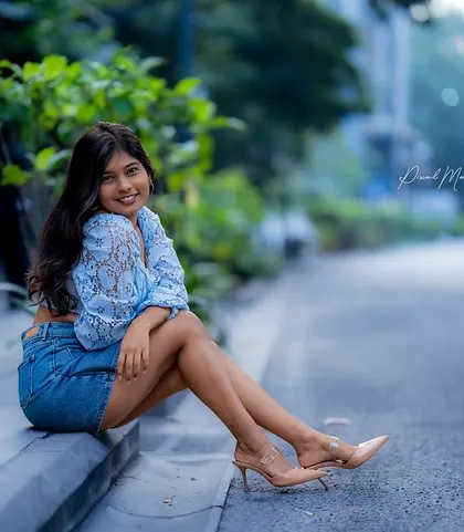 Sometimes the best location is the simplest one. This candid-style shot on a city curb captures a relaxed, authentic moment, proving you don't need a grand location to create a beautiful portrait.