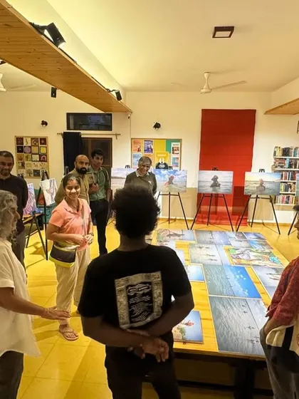 Visitors engaging with the "Chronicles of the Tides" photo exhibition. Our gallery space is designed to encourage conversation and reflection around the artwork.