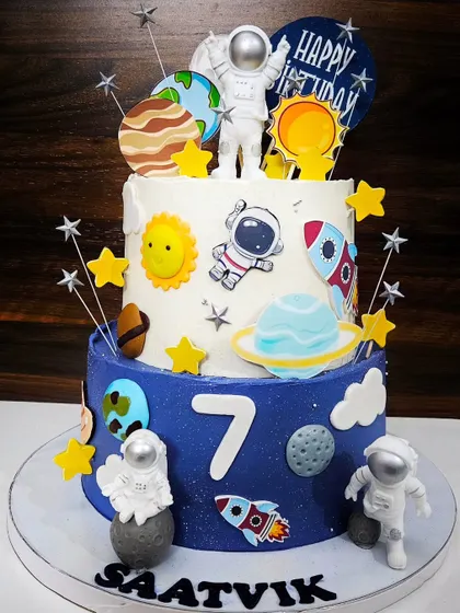 A space-themed cake for Saatvik's 7th birthday. This two-tier strawberry cake is an adventure through the solar system with astronauts, rockets, and planets.