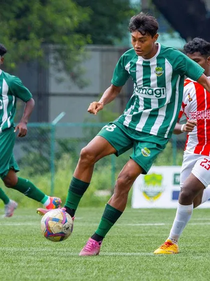 A player in full control, about to make a pass while surrounded by opponents, highlighting his awareness and composure.
