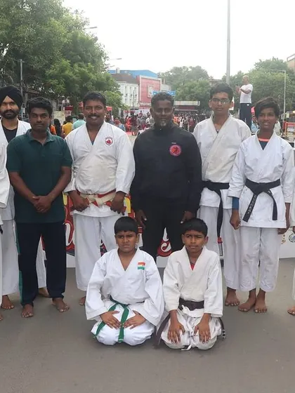 Our students alongside another karate group at the Happy Streets event. We believe in community and respect for all martial arts disciplines.